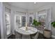 Sunlit breakfast nook features a round table and chairs, and large windows at 605 Rose Creek Cir, Duluth, GA 30097