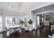 Bright dining room with a round table and chairs, hardwood floors, and large windows at 605 Rose Creek Cir, Duluth, GA 30097