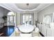 Open dining room with hardwood floors, chandelier, and access to the entryway at 605 Rose Creek Cir, Duluth, GA 30097