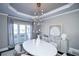Modern dining room with large windows, chandelier, and stylish decor at 605 Rose Creek Cir, Duluth, GA 30097