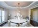 Elegant dining room featuring a round table, neutral decor, and ample natural light at 605 Rose Creek Cir, Duluth, GA 30097