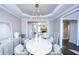 Spacious dining room with a white table, chandelier, and hardwood floors at 605 Rose Creek Cir, Duluth, GA 30097