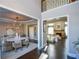 Open concept entryway with views of dining and living areas, hardwood floors at 605 Rose Creek Cir, Duluth, GA 30097