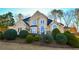 Two-story house with stucco exterior, landscaping, and a welcoming front entrance at 605 Rose Creek Cir, Duluth, GA 30097