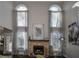 Living room fireplace with stone surround and large windows above at 605 Rose Creek Cir, Duluth, GA 30097