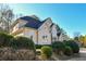 Tan house with a dark gray roof and manicured landscaping at 605 Rose Creek Cir, Duluth, GA 30097