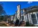 Back of house, showcasing large deck and chimney at 605 Rose Creek Cir, Duluth, GA 30097