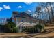 Back of house with deck and surrounding landscaping at 605 Rose Creek Cir, Duluth, GA 30097