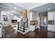 Open concept kitchen with dark hardwood floors, white cabinets, and an island at 605 Rose Creek Cir, Duluth, GA 30097