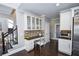 Kitchen with built-in desk and glass-front cabinets at 605 Rose Creek Cir, Duluth, GA 30097