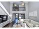Bright living room featuring hardwood floors, a sectional sofa, and a large TV at 605 Rose Creek Cir, Duluth, GA 30097