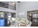 Spacious living room with high ceilings, hardwood floors, and a large sectional sofa at 605 Rose Creek Cir, Duluth, GA 30097