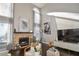 Living room with a fireplace, large TV, and plenty of natural light at 605 Rose Creek Cir, Duluth, GA 30097