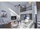 Living room features hardwood floors, a comfortable seating area, and a large TV at 605 Rose Creek Cir, Duluth, GA 30097