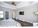 Main bedroom with dark hardwood floors and built-in media console at 605 Rose Creek Cir, Duluth, GA 30097