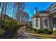 Landscaped side yard with stone wall and pathway at 605 Rose Creek Cir, Duluth, GA 30097