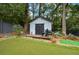 White shed with dark accents and a deck, offering extra storage at 1409 Sheridan Ne Rd, Atlanta, GA 30324