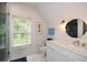 Bathroom with a walk-in shower, marble vanity, and a round mirror at 1409 Sheridan Ne Rd, Atlanta, GA 30324