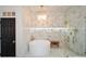 Elegant bathroom with marble herringbone tile, a freestanding tub, and a walk-in shower at 1409 Sheridan Ne Rd, Atlanta, GA 30324