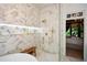 Modern bathroom featuring marble tile, a built-in bench, and a spacious shower at 1409 Sheridan Ne Rd, Atlanta, GA 30324