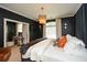 Dark and dramatic Primary bedroom with a plush bed and en-suite bathroom at 1409 Sheridan Ne Rd, Atlanta, GA 30324