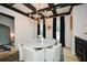 Elegant dining room with marble table, black ceiling beams, and gold chandelier at 1409 Sheridan Ne Rd, Atlanta, GA 30324