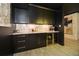 Basement wet bar with dark cabinetry and marble countertops at 1409 Sheridan Ne Rd, Atlanta, GA 30324