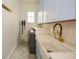 Bright laundry room with light blue cabinets and farmhouse sink at 1409 Sheridan Ne Rd, Atlanta, GA 30324