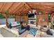 Covered patio with fireplace, TV, and comfortable seating at 1409 Sheridan Ne Rd, Atlanta, GA 30324