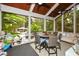 Relaxing screened porch with seating area, dining table, and view of the backyard at 1409 Sheridan Ne Rd, Atlanta, GA 30324