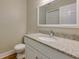 Bathroom with granite countertop, white vanity, and updated fixtures at 242 Chads Ford Way, Roswell, GA 30076