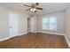 Bright bedroom featuring hardwood floors and ceiling fan at 242 Chads Ford Way, Roswell, GA 30076