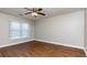 Spacious bedroom with hardwood floors and ceiling fan at 242 Chads Ford Way, Roswell, GA 30076