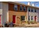 Two-story townhome with red door and brick facade at 242 Chads Ford Way, Roswell, GA 30076