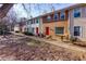 Front view of townhouses with red doors and landscaping at 242 Chads Ford Way, Roswell, GA 30076