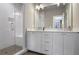 Modern bathroom with double vanity, walk-in shower, and white cabinets at 308 Gibson Se St, Atlanta, GA 30316