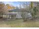 Rear view of house showing gray siding, patio, and wooded area at 2315 Barge Sw Rd, Atlanta, GA 30331