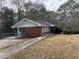 Brick ranch home with a deck and landscaped yard at 4515 Wonder Valley Trl, Decatur, GA 30034