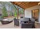 Covered back patio with wicker furniture and a view of the backyard at 1240 Roswell Manor Cir, Roswell, GA 30076