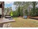 Grass backyard with deck, hanging chair and trees at 1240 Roswell Manor Cir, Roswell, GA 30076