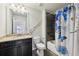 Bathroom features granite countertop, dark brown vanity, and a shower/tub combo at 1240 Roswell Manor Cir, Roswell, GA 30076