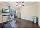 Home office with hardwood floors, treadmill, and built-in shelving at 1240 Roswell Manor Cir, Roswell, GA 30076