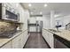 Spacious kitchen featuring granite countertops, stainless steel appliances, and dark hardwood floors at 1240 Roswell Manor Cir, Roswell, GA 30076