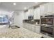 Modern kitchen with double ovens, granite counters, and stylish backsplash at 1240 Roswell Manor Cir, Roswell, GA 30076