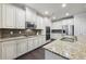 Gourmet kitchen with granite countertops, stainless steel appliances, and an island at 1240 Roswell Manor Cir, Roswell, GA 30076