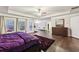 Main bedroom with hardwood floors, purple bedding, and sitting area at 1240 Roswell Manor Cir, Roswell, GA 30076