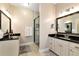 Elegant bathroom with double vanity, granite countertop, and frameless shower at 1420 Arblay Pl, Loganville, GA 30052