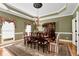 Formal dining room with hardwood floors, chandelier, and large windows at 1420 Arblay Pl, Loganville, GA 30052