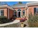 Front entry with a covered porch and brick accents at 1420 Arblay Pl, Loganville, GA 30052