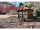 Wooden gazebo near brick home, nestled amongst lush greenery and foliage at 1420 Arblay Pl, Loganville, GA 30052